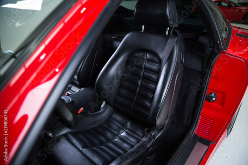 Detail of black leather sports car seat © camerarules