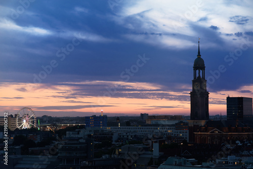 Ferris Wheel of Hamburg's Dom and St. Michael's church at sunset © Dennis Gross