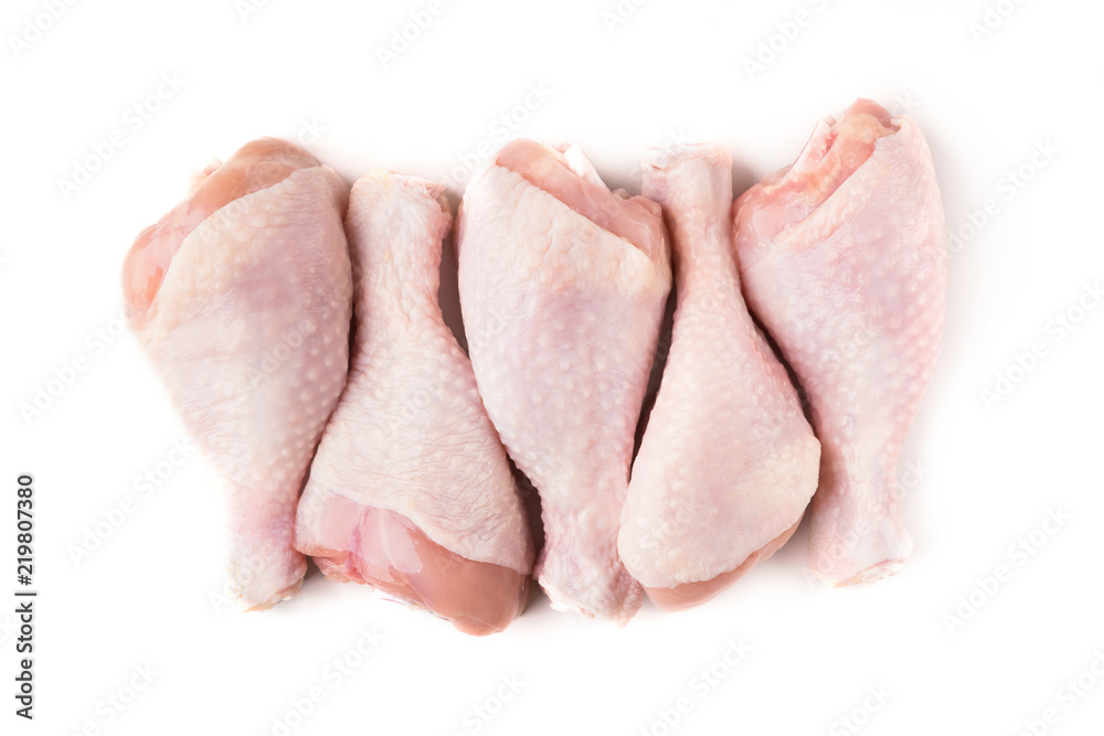 Uncooked chicken legs on white background