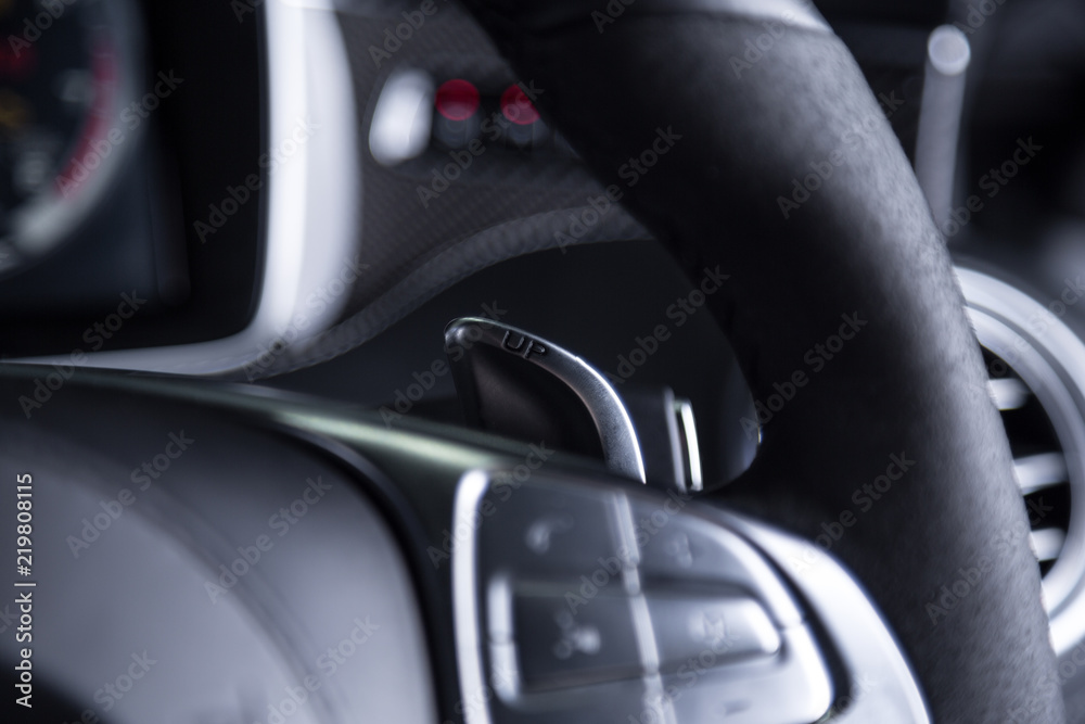 Close up of paddle shift on car steering wheel