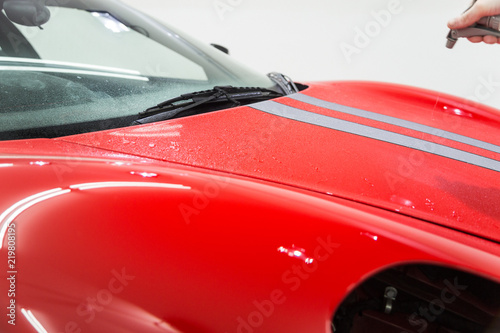 Spraying on red sports car  © camerarules