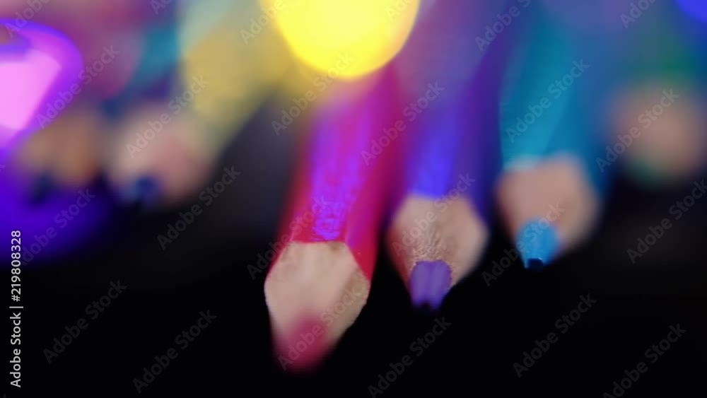 Colored pencils and defocused lights. Close up trucking shot. Shallow depth of field. 4K resolution Colored pencils and defocused lights. Close up trucking shot. Shallow depth of field. 4K resolution