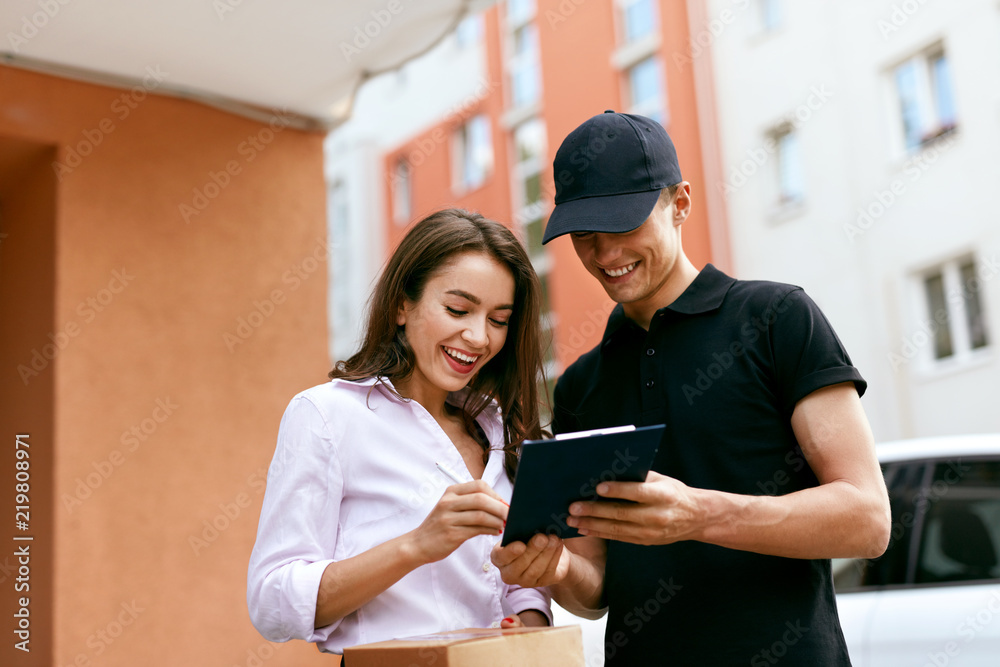 Delivery Courier. Man Delivering Package To Woman Delivery Courier. Man Delivering Package To Woman