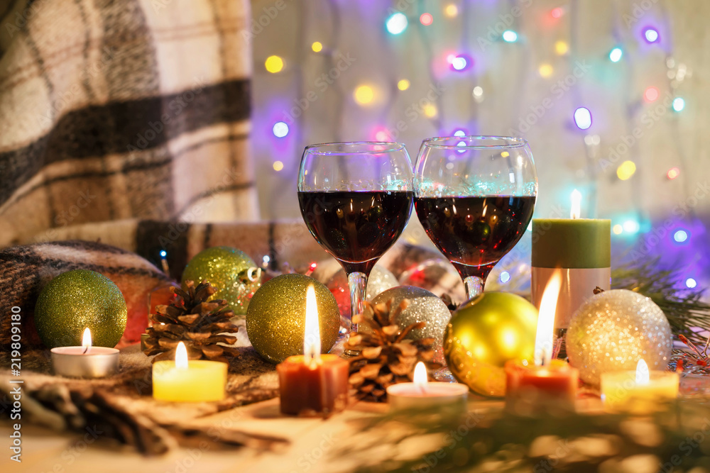 Two glasses of wine in the New Year decorations. Christmas background. New Year's lights