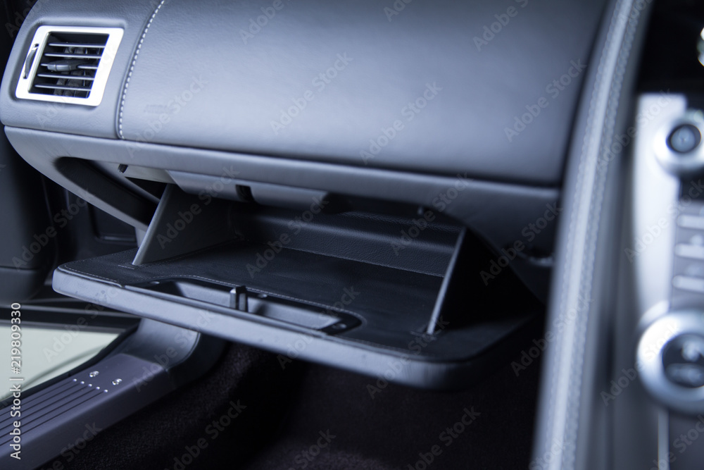 Storage compartment in black car interior