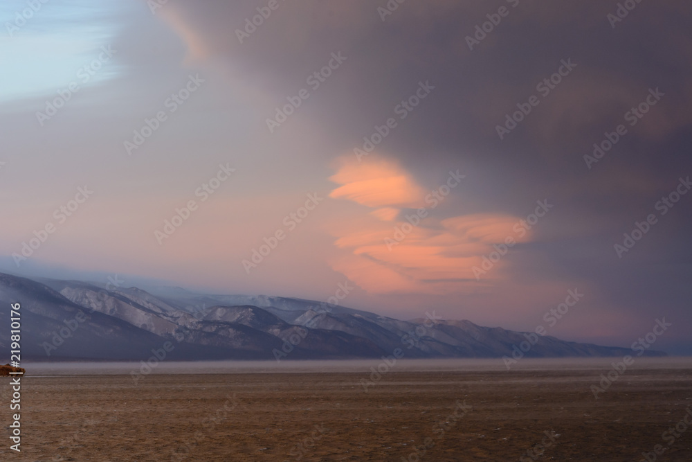 vortex clouds at sunset on the lake Baikal