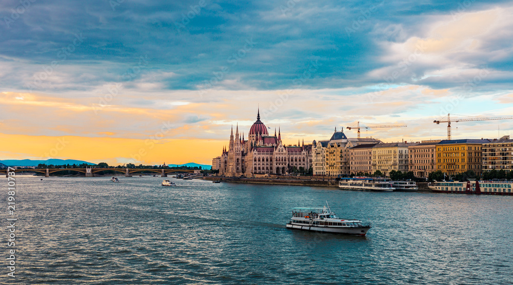 Boat on the Danube river, Hungarian Parliament Building sunset in Budapest