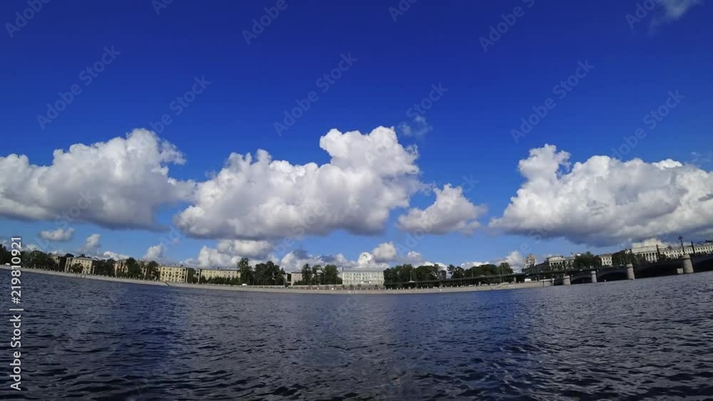 Time lapse of rolling cumulus clouds on a sunny day. Embankment of a Neva river in St. Petersburg, Russia. Time lapse of rolling cumulus clouds on a sunny day. Embankment of a Neva river in St. Petersburg, Russia.