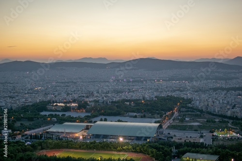 Image shows sunset and a view of the city of Athens-Greece.