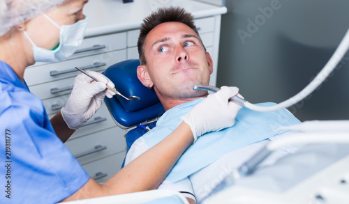 Young man frightened by dentist