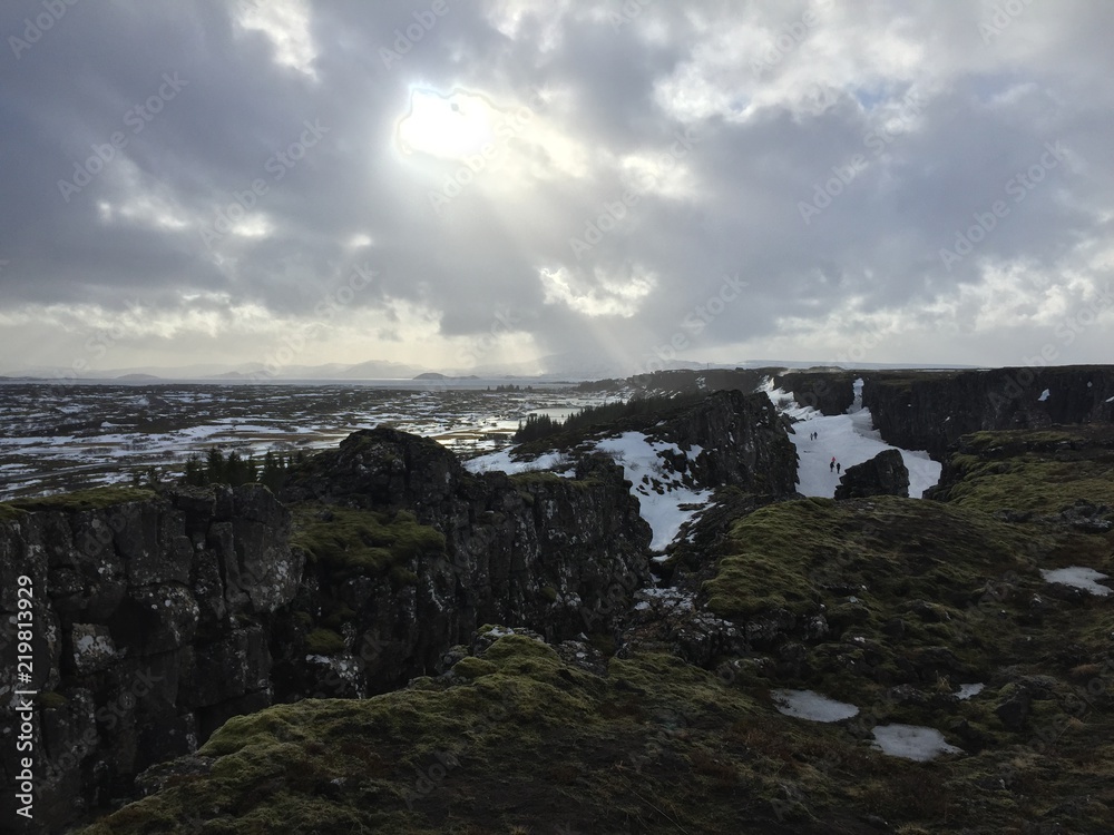 Sunlight breaking through icelandic rocky landscape, clouds, hiking, nature, outdoors