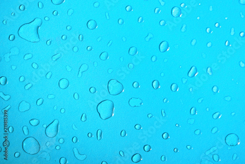 Water drops on a blue glass