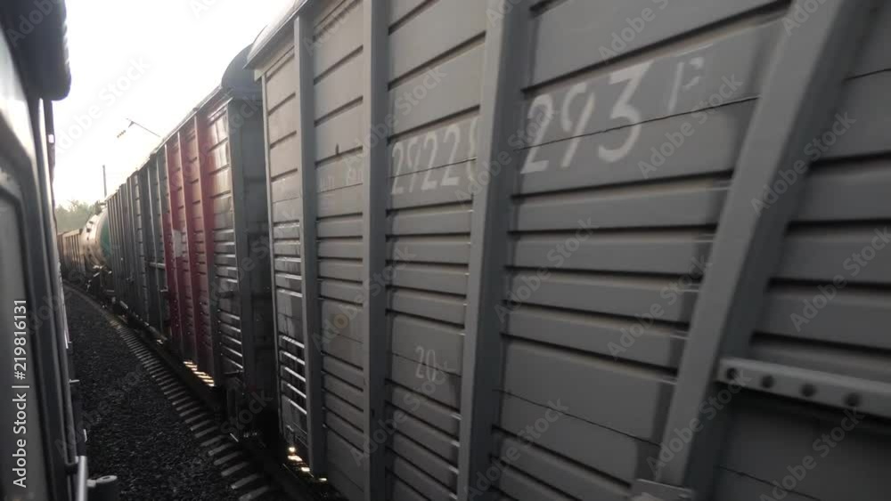 Railroad freight railroad car cars train ride on rails near the forest railway outside. slow motion video. The train with the carriages moves next to the forest. concept railroad train cars and train Railroad freight railroad car cars train ride on rails near the forest railway outside. slow motion video. The train with the carriages moves next to the forest. concept railroad train cars and train