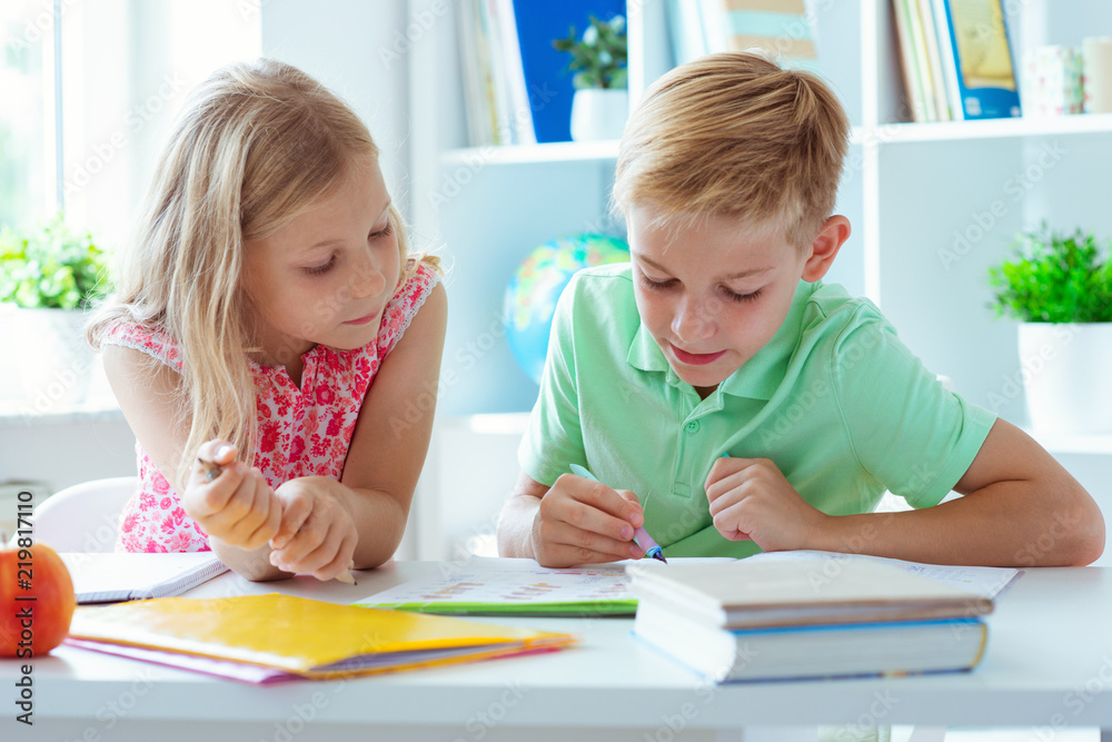 Schoolchildren are came back to school and learning at the table in classroom Schoolchildren are came back to school and learning at the table in classroom