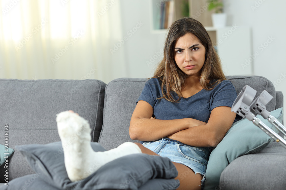 Angry disabled woman looking at camera at home Angry disabled woman looking at camera at home