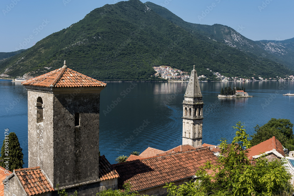 The ancient orthodox church in Perast in Montenegro. In the distance can be seen the island of our lady of the rocks that sits in the bay of kotor.
