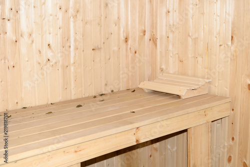 interior of a wooden sauna with a sun bed and a headrest photo