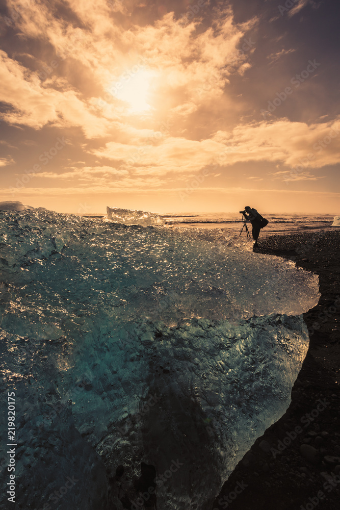 Photographer take a photo and view of jokulsalon glacier beach during sunset in iceland