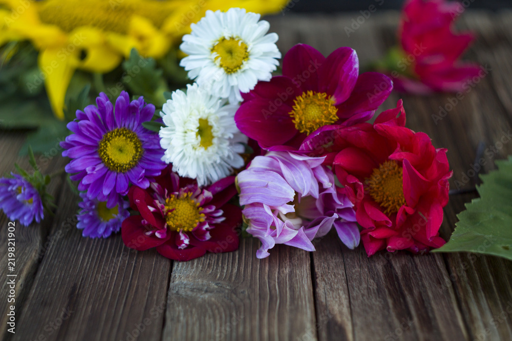 Flowers frame on wooden background. Top view with copy space