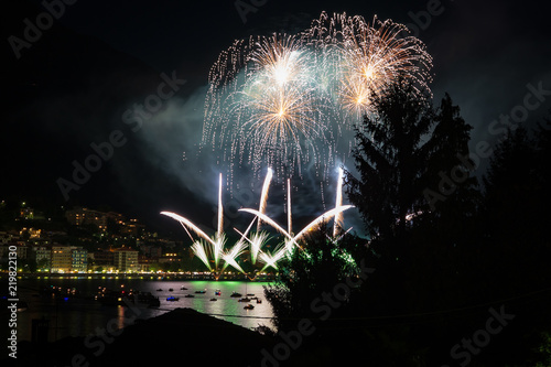 panoramic view of omegna during a fireworks display photo