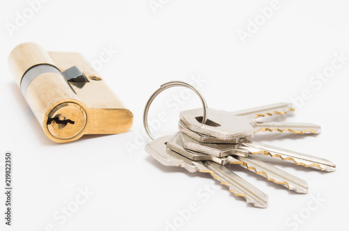 door lock cylinder with bunch of keys on white background