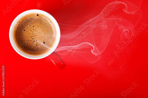 Fragrant coffee on a red background for your advertising. Smoke from hot coffee.