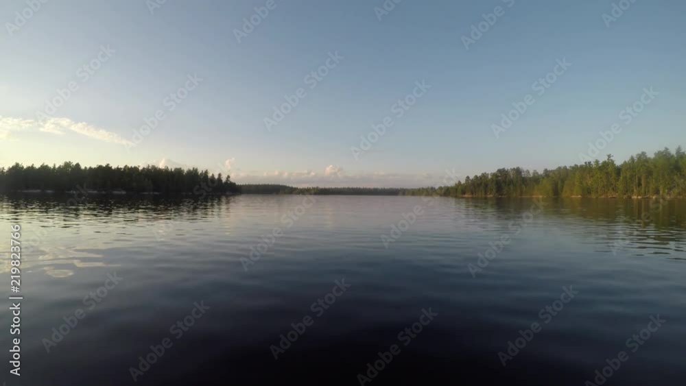 Boating Across The Smooth Water of Rainy Lake in Minnesota Boating Across The Smooth Water of Rainy Lake in Minnesota