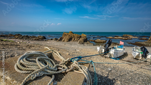 Mooring Boat With Rope Tied On Sand Beach