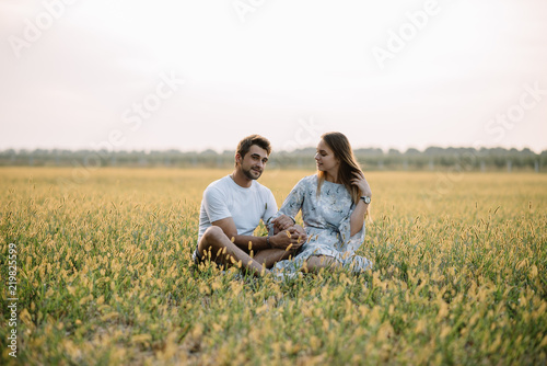 A girl and a guy are walking in the park. Portrait of a couple, a love story. Happy smiling, loveling couple together outstretched at beautiful nature. Lovestory