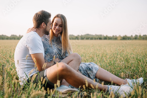 A girl and a guy are walking in the park. Portrait of a couple, a love story. Happy smiling, loveling couple together outstretched at beautiful nature. Lovestory photo