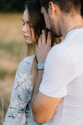 A girl and a guy are walking in the park. Portrait of a couple, a love story. Happy smiling, loveling couple together outstretched at beautiful nature. Lovestory photo