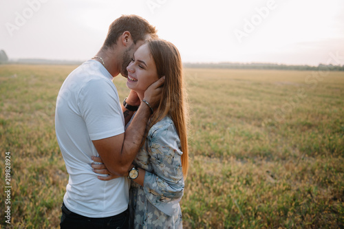 A girl and a guy are walking in the park. Portrait of a couple, a love story. Happy smiling, loveling couple together outstretched at beautiful nature. Lovestory photo