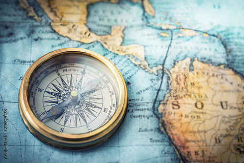 Magnetic compass on world map.Travel, geography, navigation, tourism and exploration concept background. Macro photo. Very shallow focus.