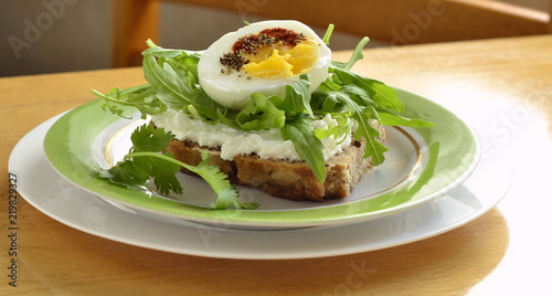 Toast with cream cheese, arugula and boiled egg, healthy breakfast