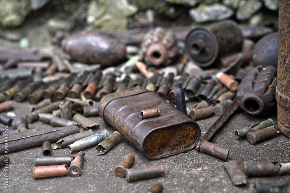 Military background with cartridges of grenades and machine-gun tape. Black archeology. World War II and its artifacts. Great Patriotic War of the USSR Military background with cartridges of grenades and machine-gun tape. Black archeology. World War II and its artifacts. Great Patriotic War of the USSR