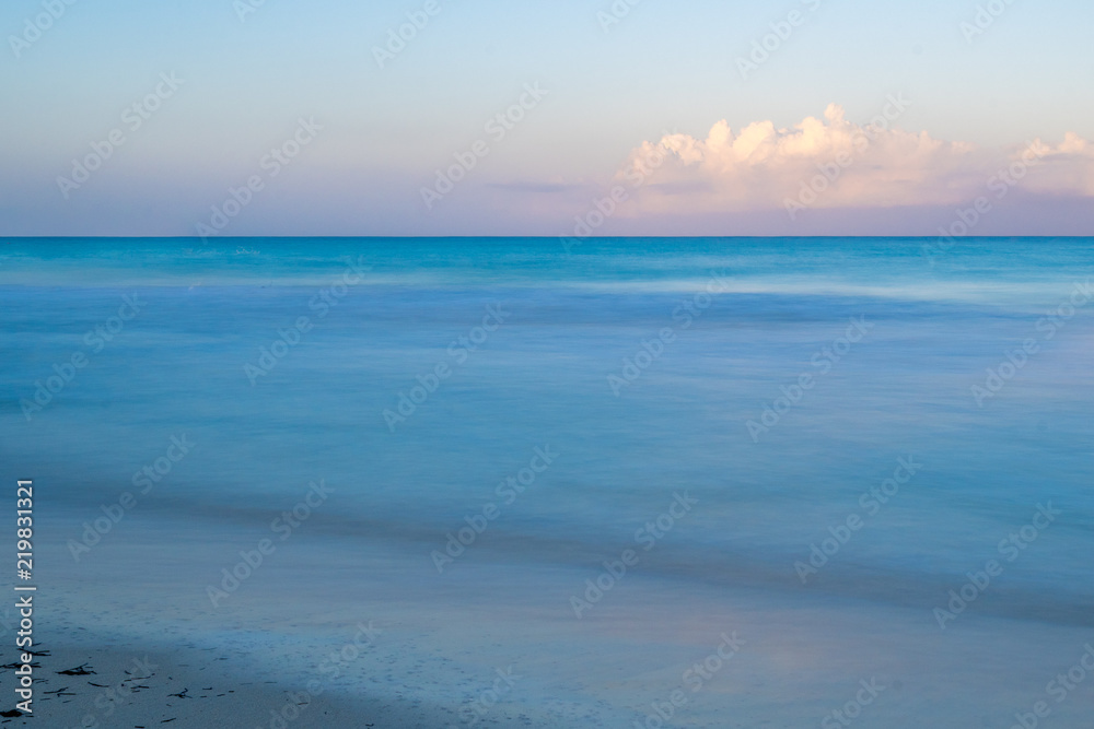 A calm beautiful morning on the beach as the sun rises in Negril, Jamaica