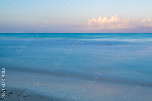 A calm beautiful morning on the beach as the sun rises in Negril, Jamaica