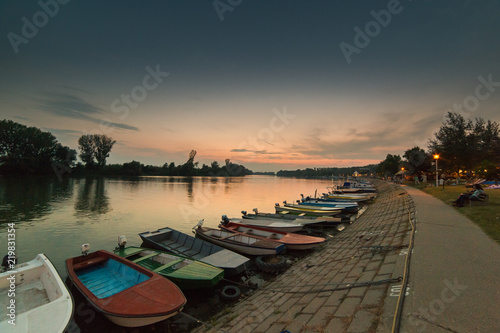 Anchored boats on a river bank