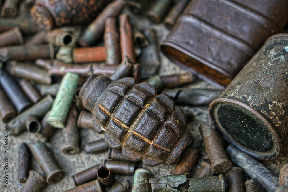 Military background with cartridges of grenades and machine-gun tape. Black archeology. World War II and its artifacts. Great Patriotic War of the USSR Military background with cartridges of grenades and machine-gun tape. Black archeology. World War II and its artifacts. Great Patriotic War of the USSR