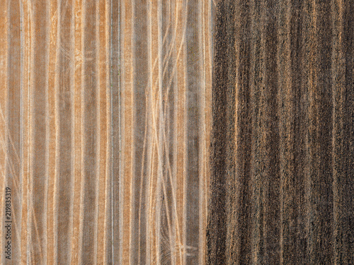 A view from above on a piece of agricultural field after harvesting and on prepared for planting works.