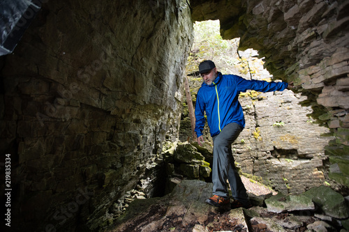 Man hikes through crevice caves on the Niagara Escarpment.