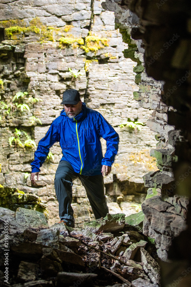 A man hiking through crevice caves on the Niagara Escarpment.