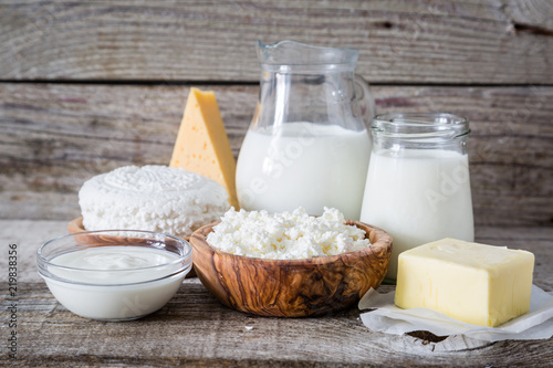 Selection of dairy products on rustic wood background