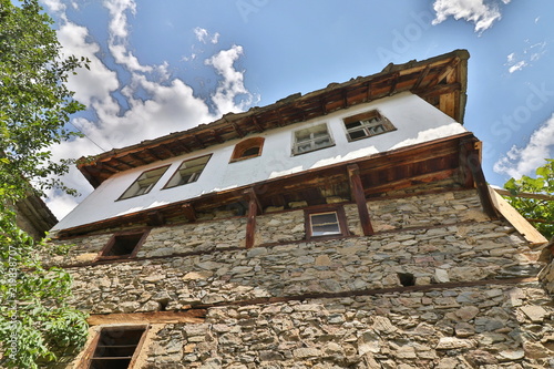 Stone house with stone fence in the Village of Leshten. Historical, facade. The Village of Leshten is architectural reservation photo