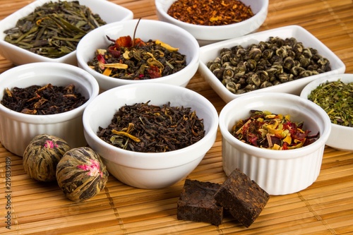 Aromatic Dried Tea Leaves in Bowls on Bamboo Mat