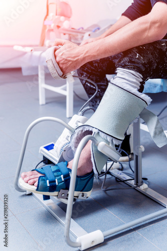 Patient on CPM (continuous passive range of motion) machines. Device to provide anatomically correct motion to both the ankle and subtalar joints. photo