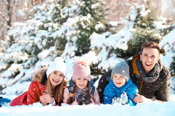 Portrait of happy family in winter park