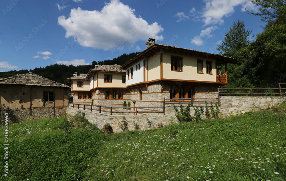 Stone house with stone fence in the Village of Leshten. Historical, facade. The Village of Leshten is architectural reservation