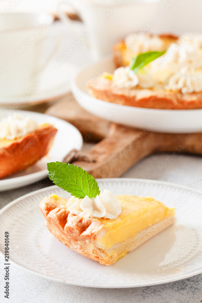 Traditional shortcrust pastry lemon tart with citrus custard and whipped cream Traditional shortcrust pastry lemon tart with citrus custard and whipped cream