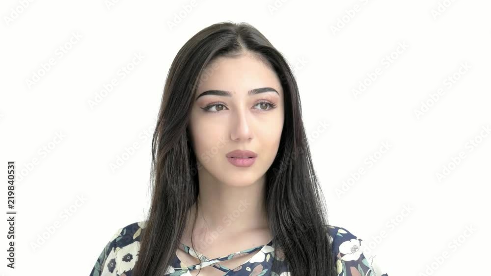 portrait of a young beautiful hispanic girl looking at the camera.brunette correct her hair portrait of a young beautiful hispanic girl looking at the camera.brunette correct her hair